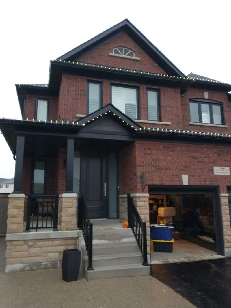 New brick home with black windows and a black front door, installed by Panorama Windows & Doors New brick home with black windows and a black front door
