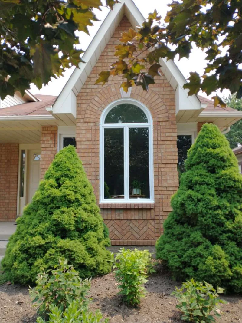 Arched picture window on a brick home