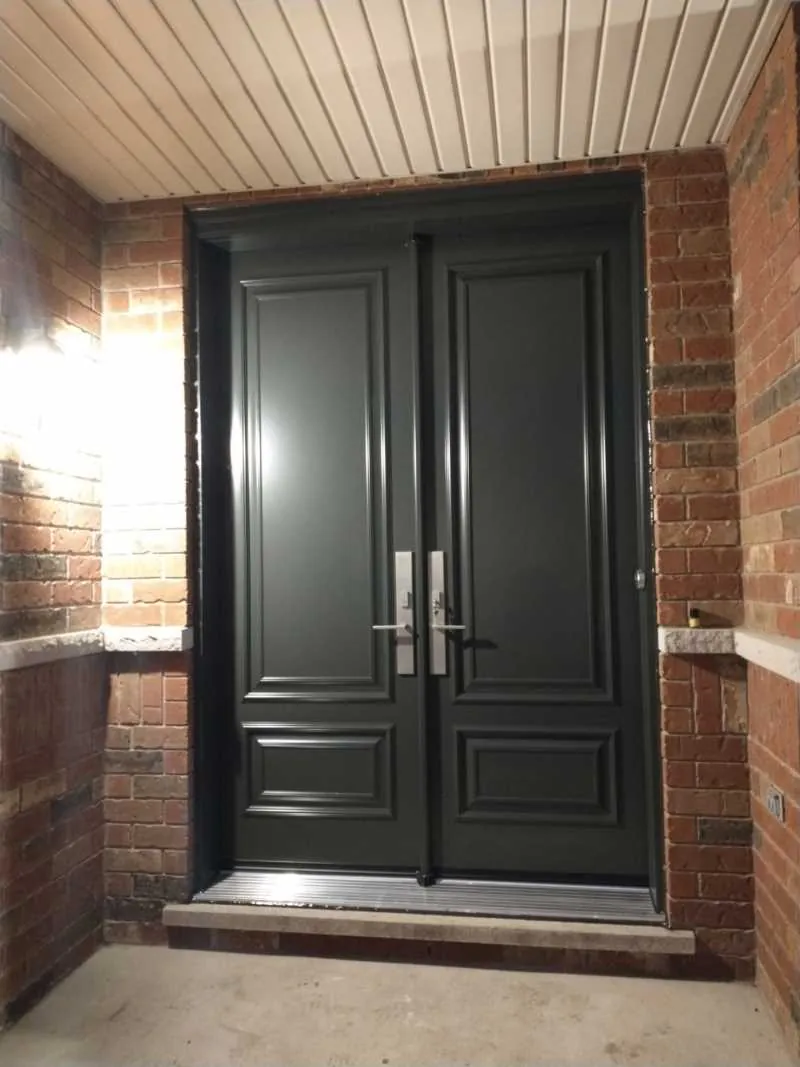 Black double entry doors on a brick porch