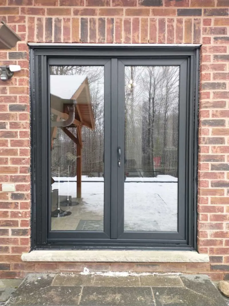 Black French patio doors on red brick
