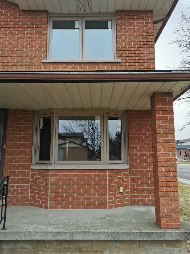 New windows on a brick home with a front porch