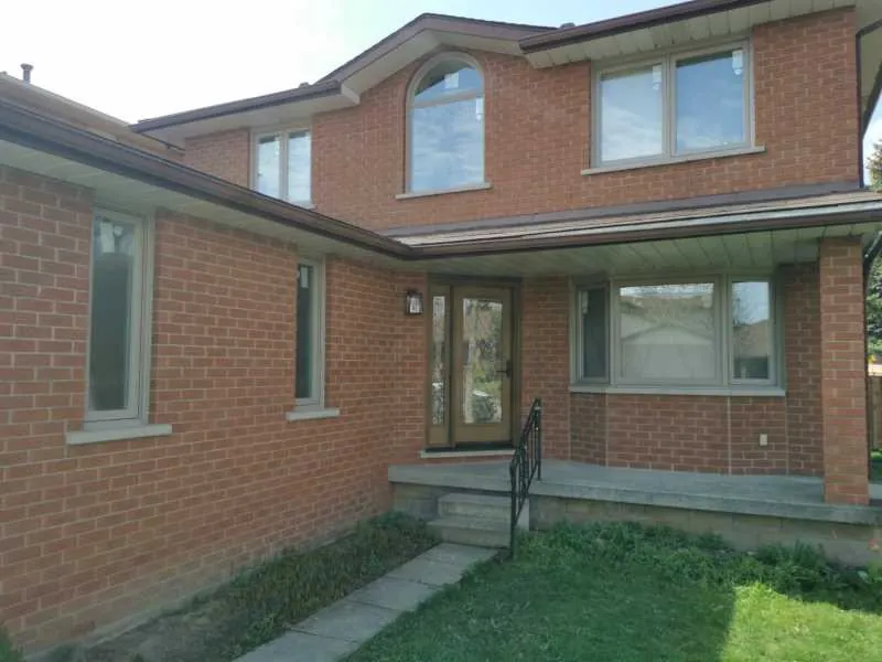 New windows on the back of a red brick home