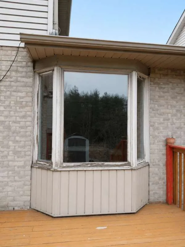 Bay Window Upgrade: before Worn bay window with peeling frames on a Barrie home, before replacement
