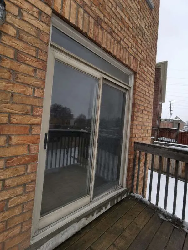 Sliding Patio Door Replacement: before Old sliding patio door onto a deck in Orillia, before replacement