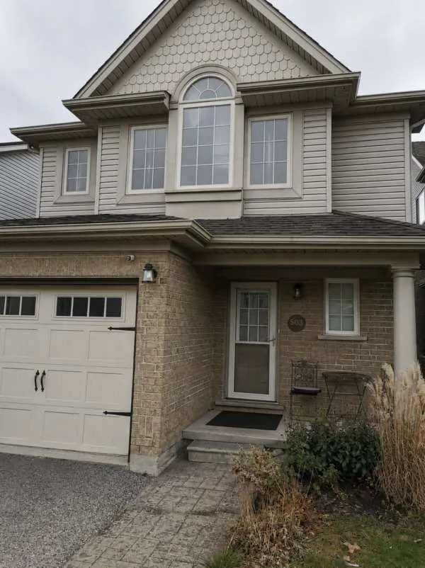Full Front Window Transformation: before Two-storey Barrie home with its original front windows, before replacement
