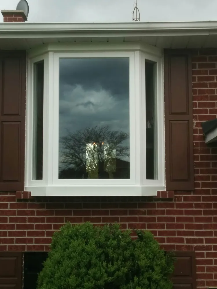 Bay window with shutters on red brick in Oshawa, installed by Panorama Windows & Doors Bay window with shutters on red brick in Oshawa