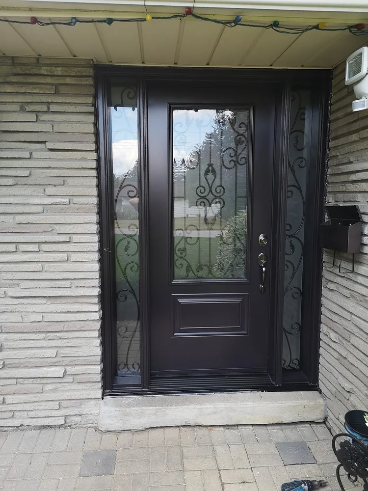 Black door with wrought-iron glass and sidelights in Sudbury