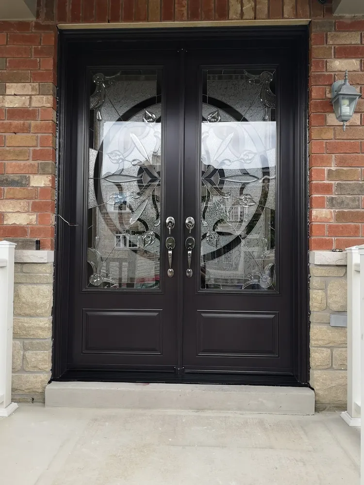 Black double doors with wrought-iron glass in Hamilton