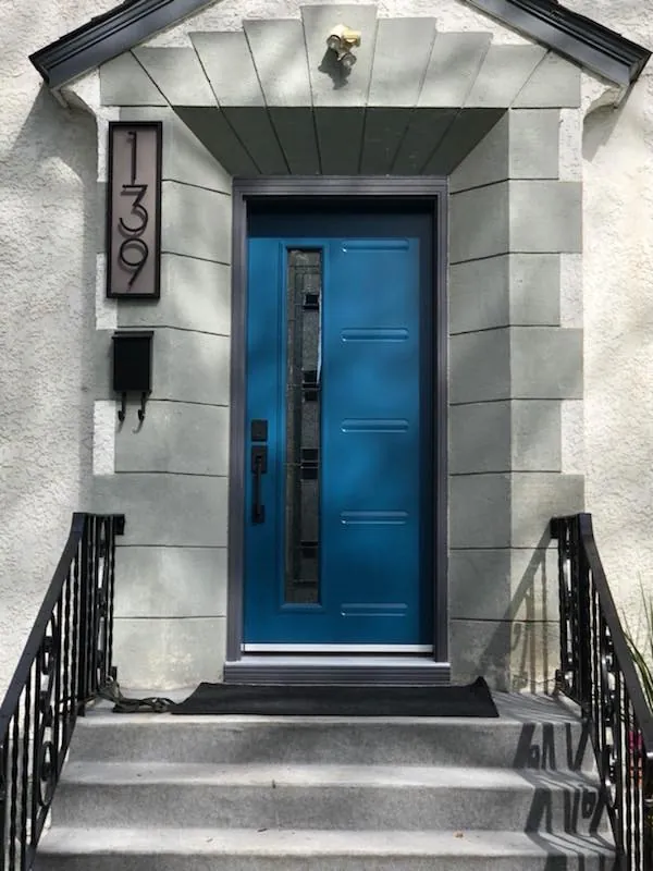 Blue modern front door on a stone porch in Innisfil, installed by Panorama Windows & Doors Blue modern front door on a stone porch in Innisfil