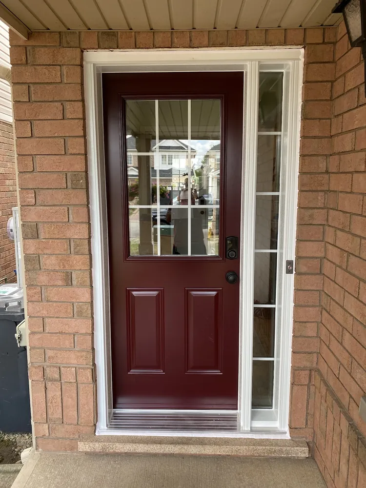 Burgundy front door with a grilled sidelight in Brampton
