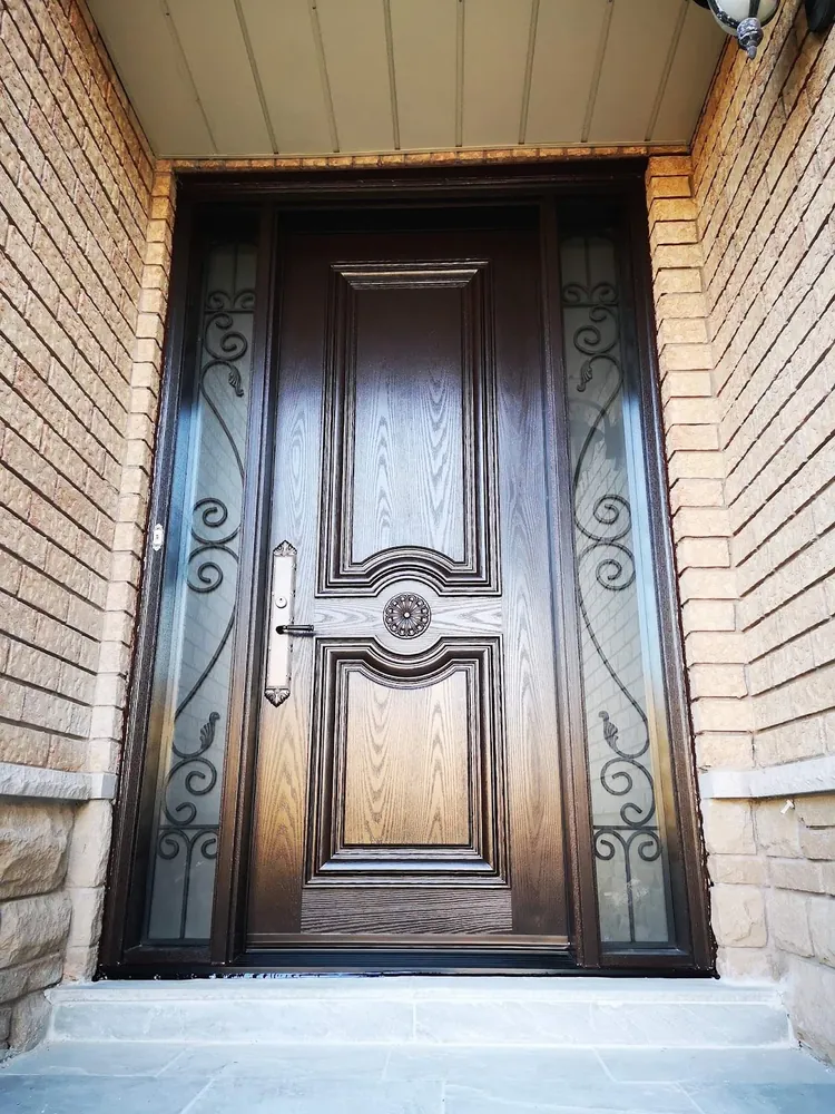 Carved wood-grain fiberglass door with wrought-iron sidelights