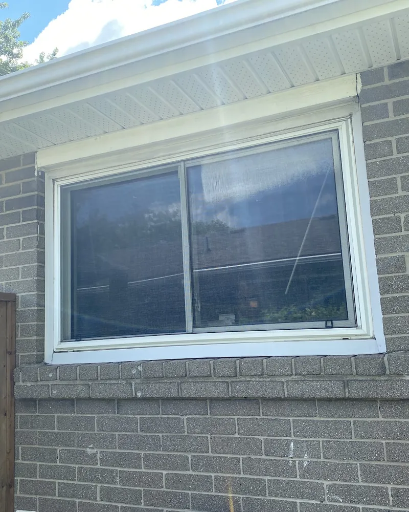 Slider Window to Casement on Grey Brick: before Window on a grey brick bungalow before replacement in Brampton