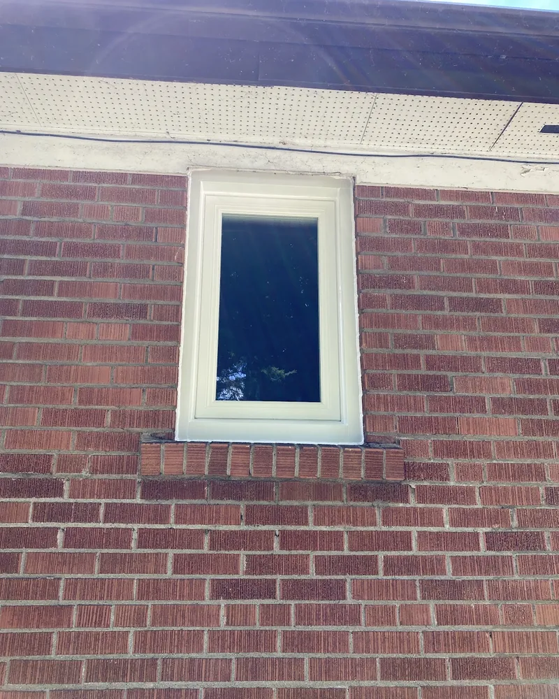Old Hung Window to New Casement: after Small window on a brick wall after replacement