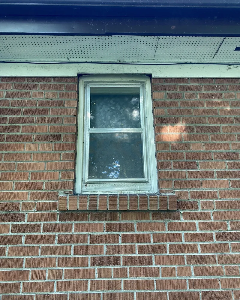 Old Hung Window to New Casement: before Small window on a brick wall before replacement