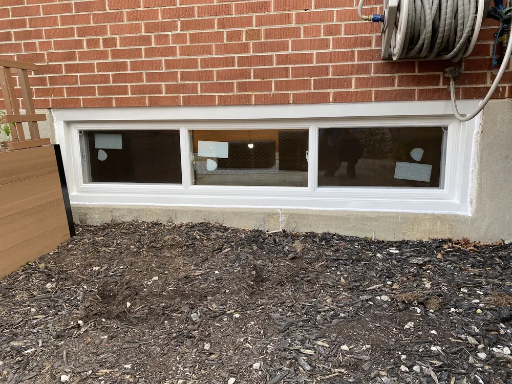 End vent slider window on a brick foundation