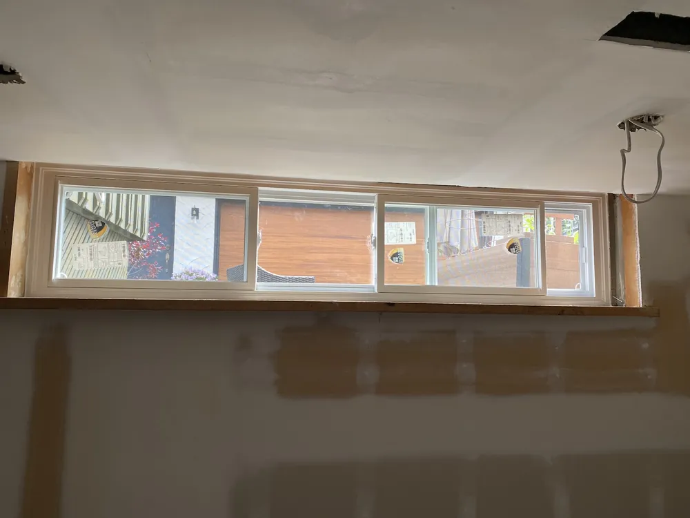 End vent slider window in a finished basement
