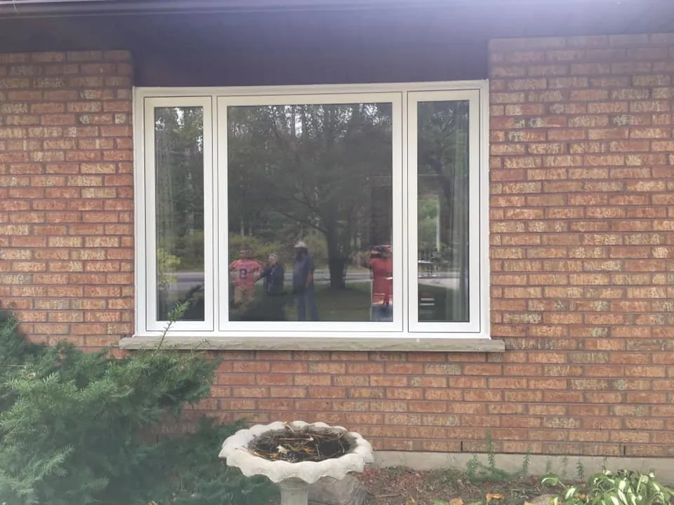 Fixed centre window with casements on red brick