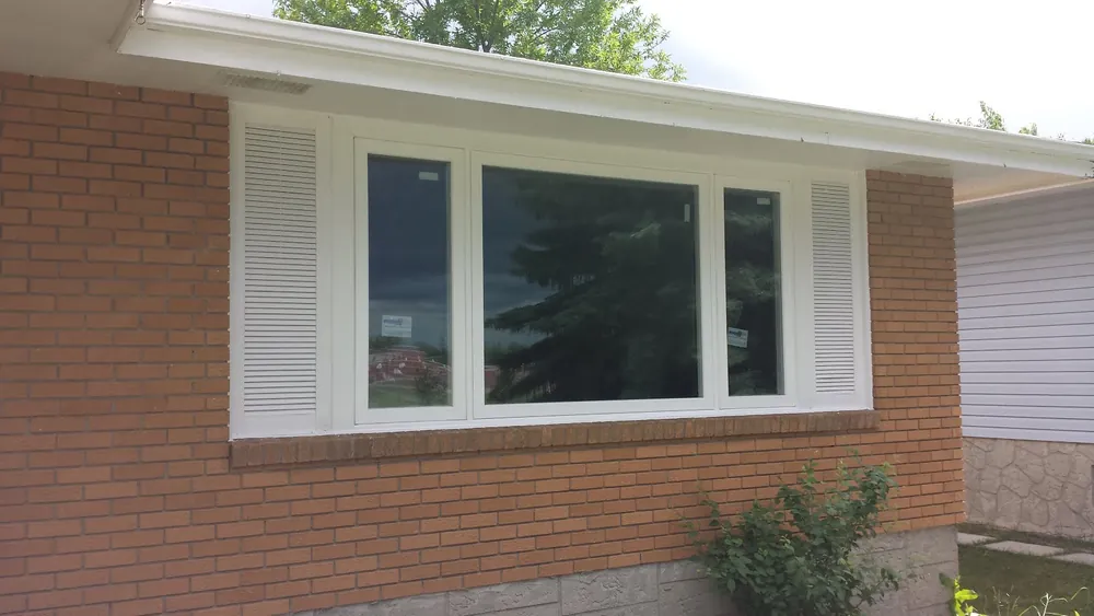 Fixed picture window with casement windows on a brick bungalow