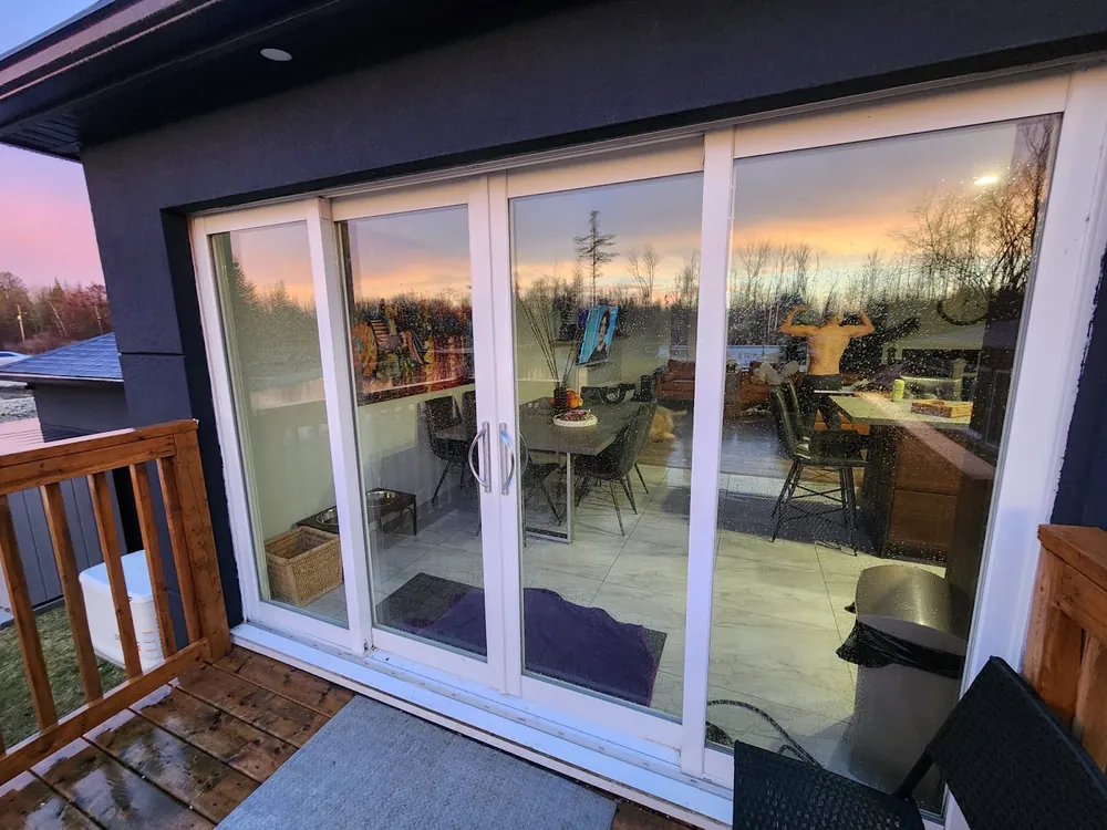 Four-panel sliding patio door at dusk
