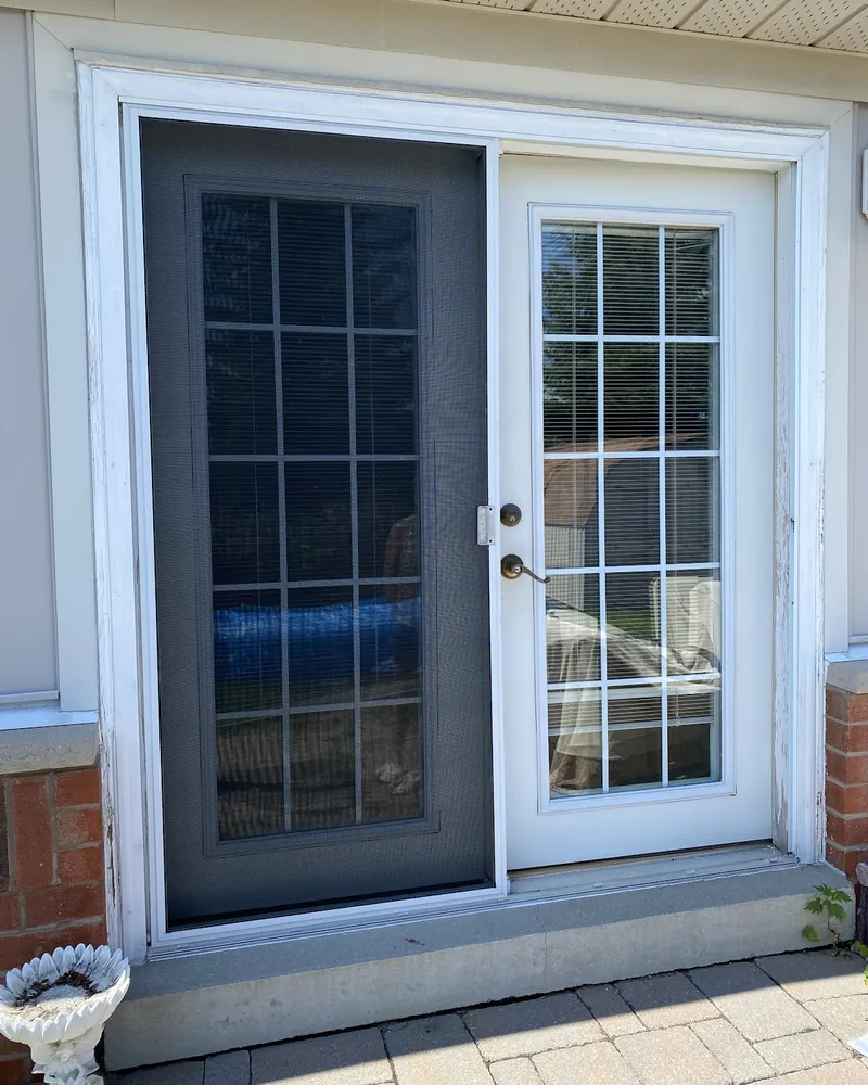 Garden Door to White French Doors: before Patio doors on a siding wall before replacement in Oshawa