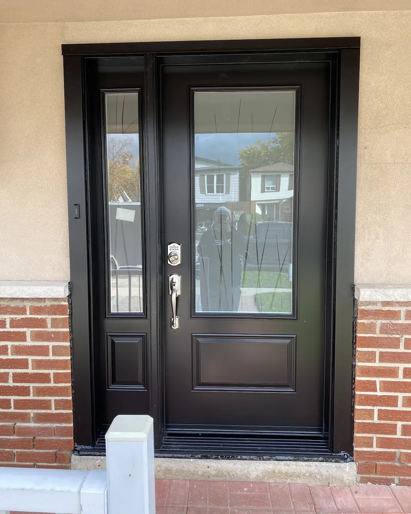 Front Door and Sidelight Upgrade: after Front door with a sidelight on a stucco porch after replacement in Burlington