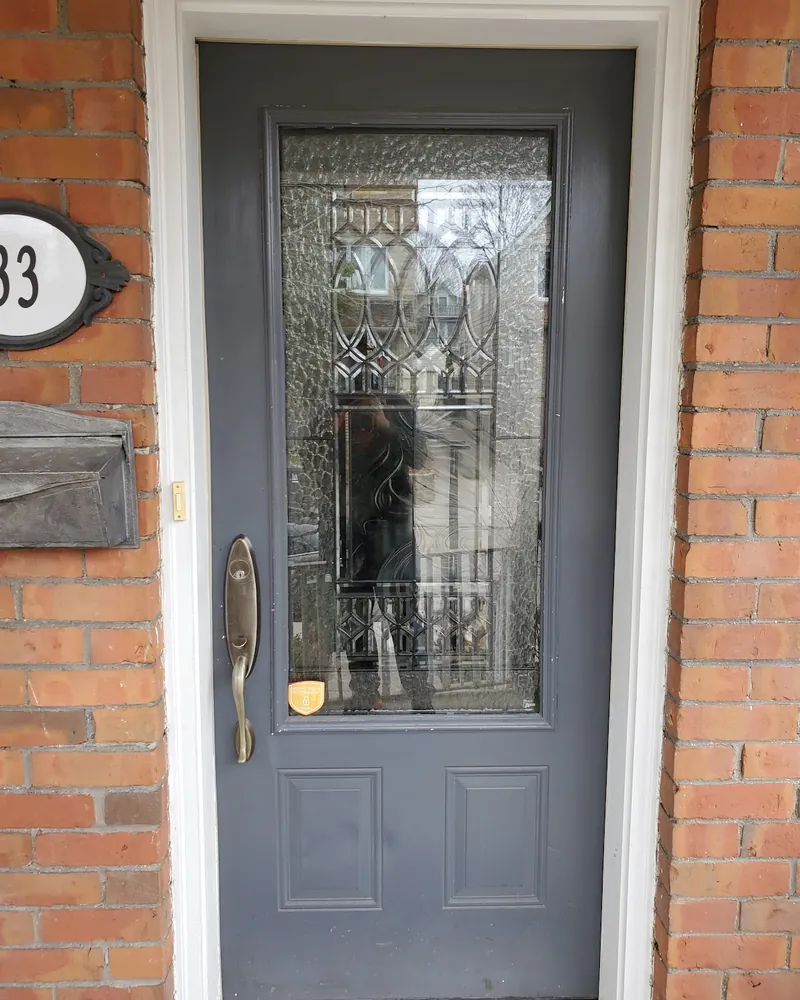 Grey Front Door to Navy Door With Glass: before Front door on a brick porch before replacement