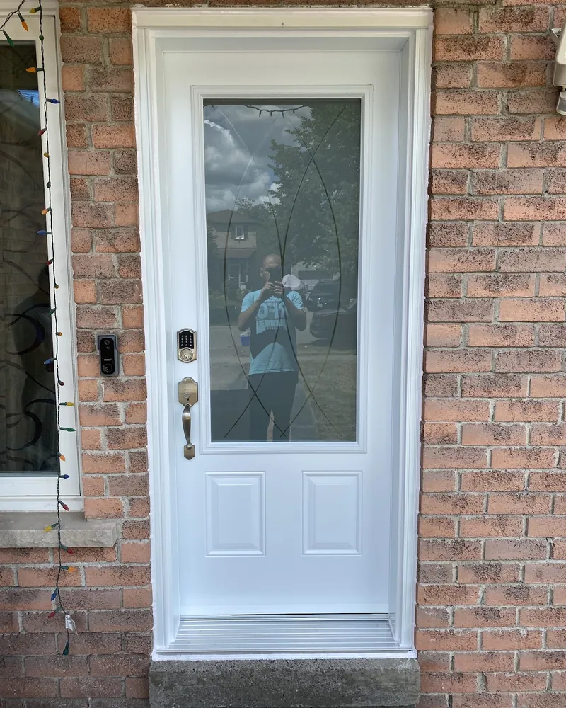 White front door on a brick porch after replacement