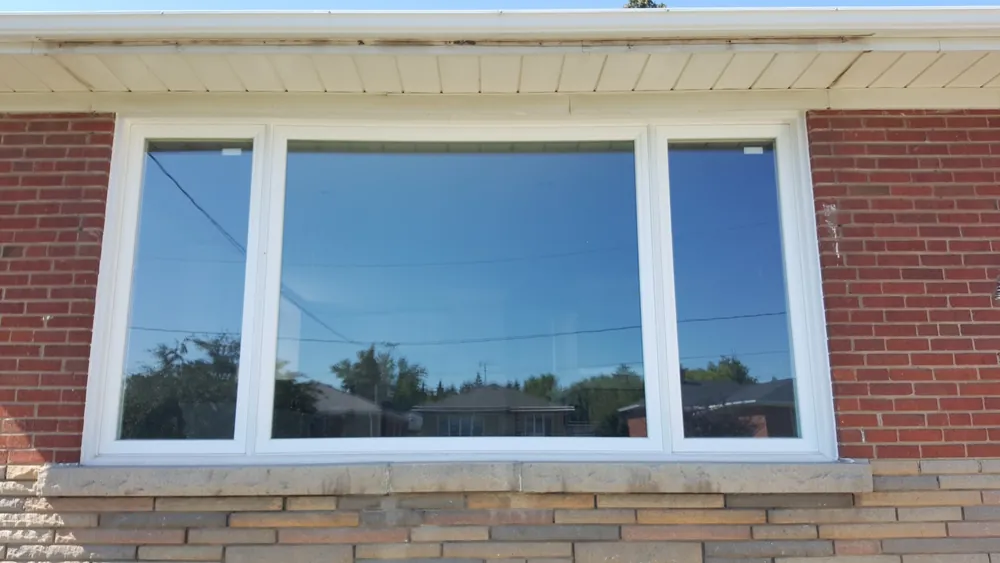 Large picture window on a brick bungalow