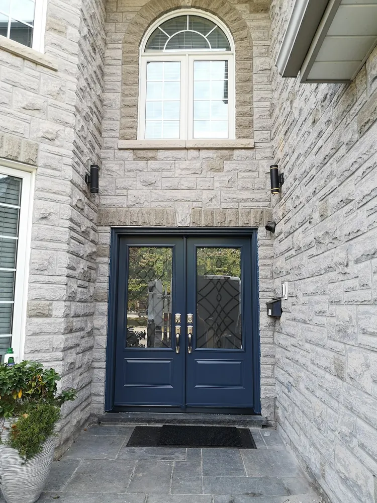 Navy double doors on a stone home in Hamilton