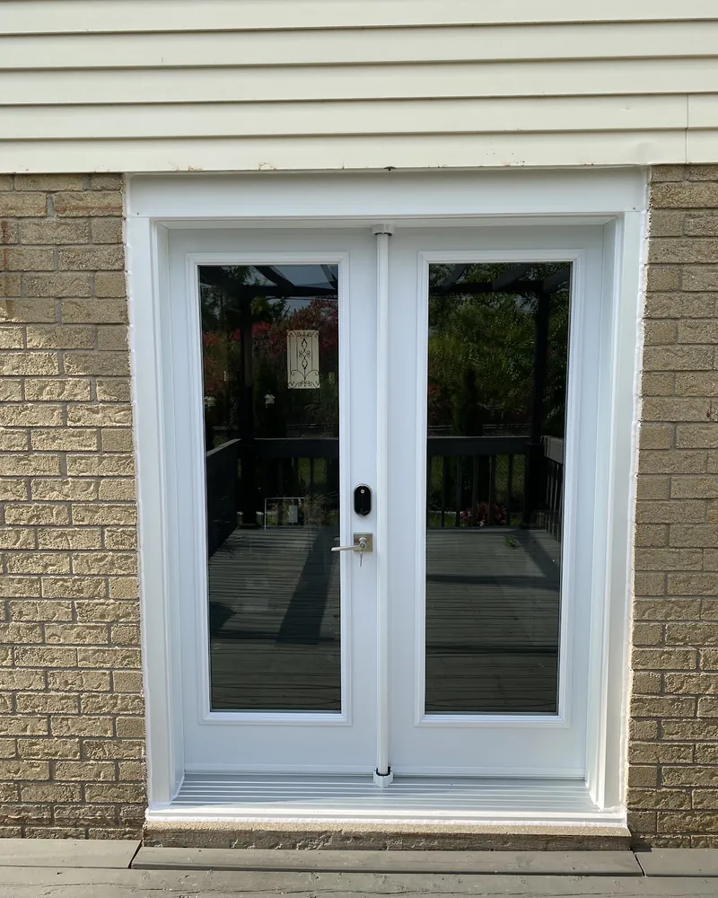 Sliding Door to White French Doors: after Rear patio door onto a deck after replacement