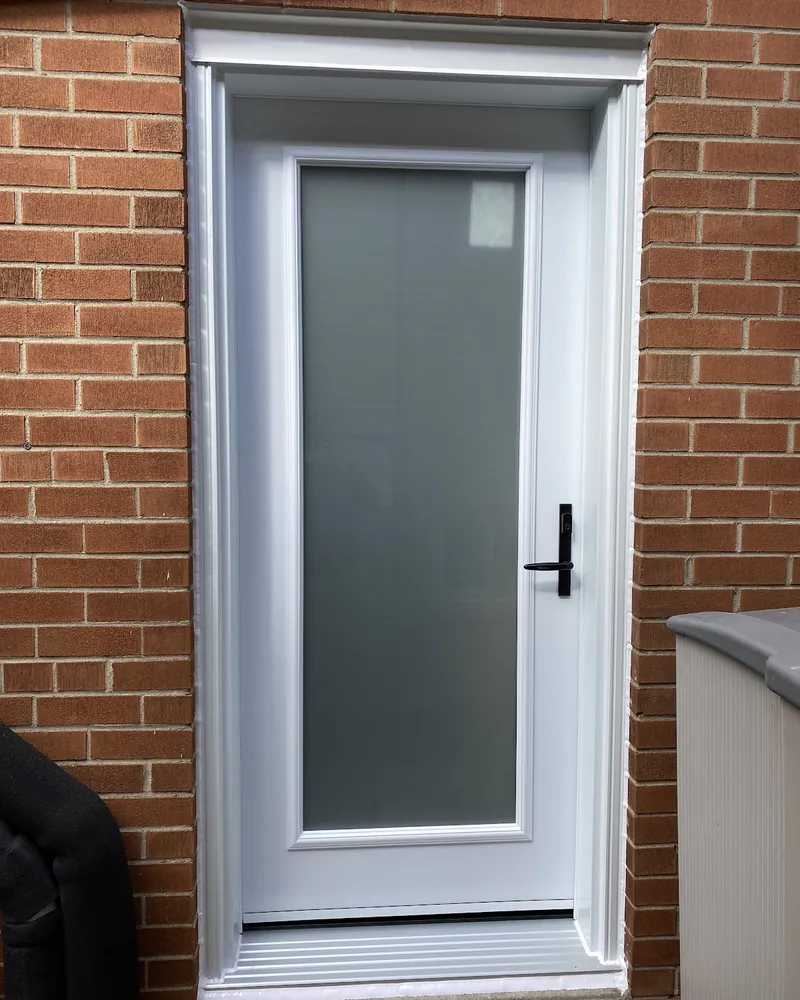 Side Door and Storm Door Replaced: after Side entrance door on a brick wall after replacement