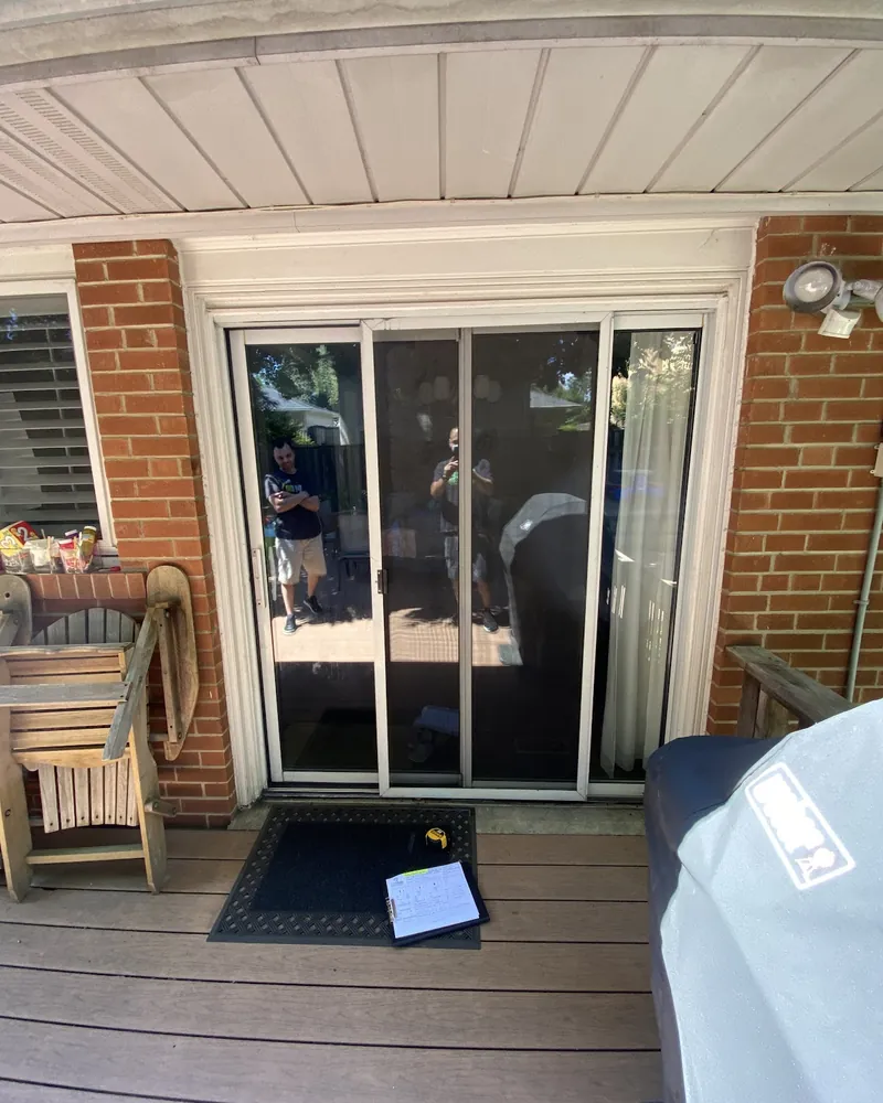 Sliding patio door on a covered deck before replacement