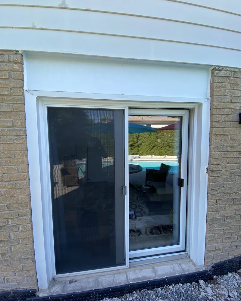 Walkout Patio Door Replacement: before Lower-level walkout patio door before replacement