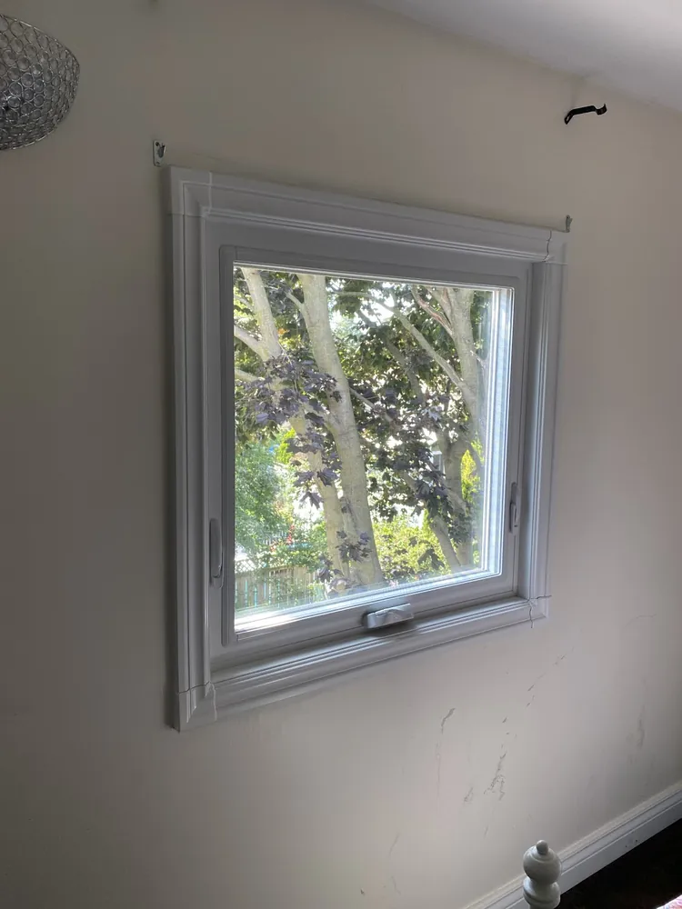 White awning window in a bedroom