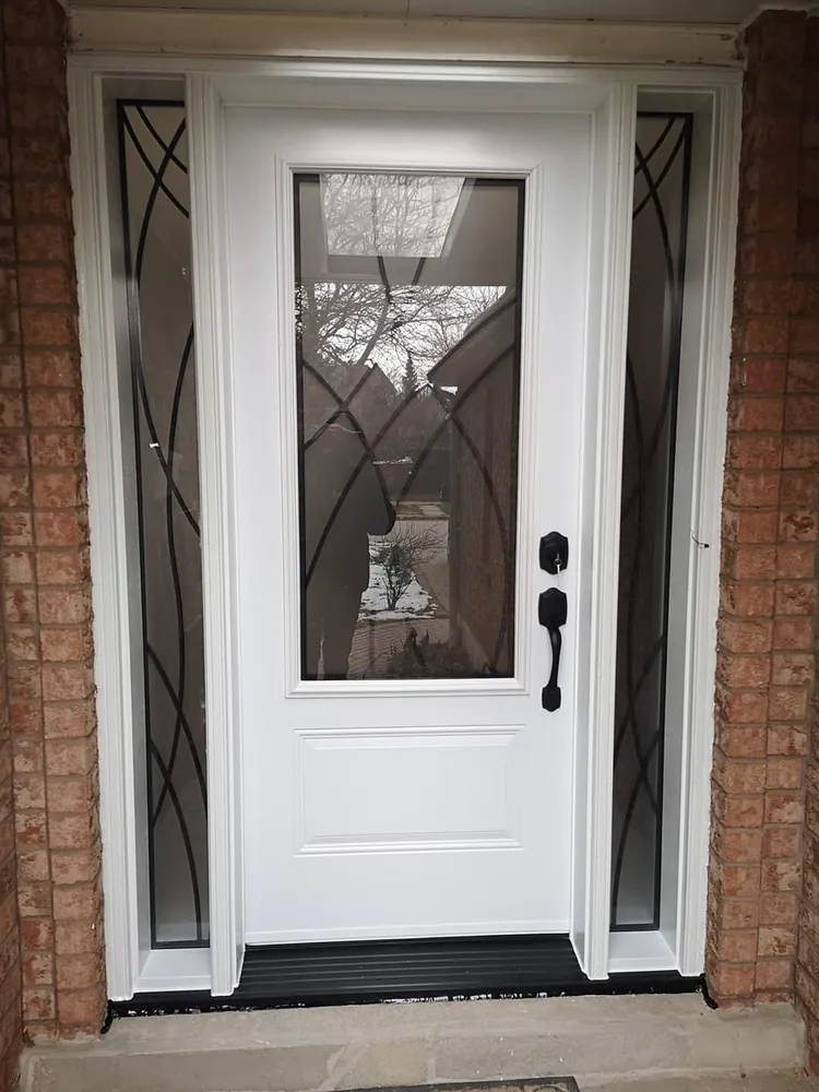 White front door with decorative glass and sidelights in Sudbury