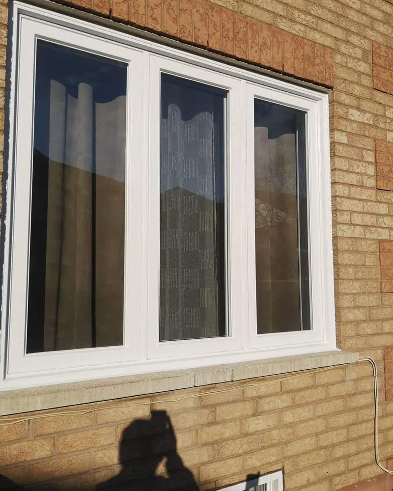 White vinyl triple casement window on yellow brick installed by Panorama Windows & Doors White vinyl triple casement window on yellow brick