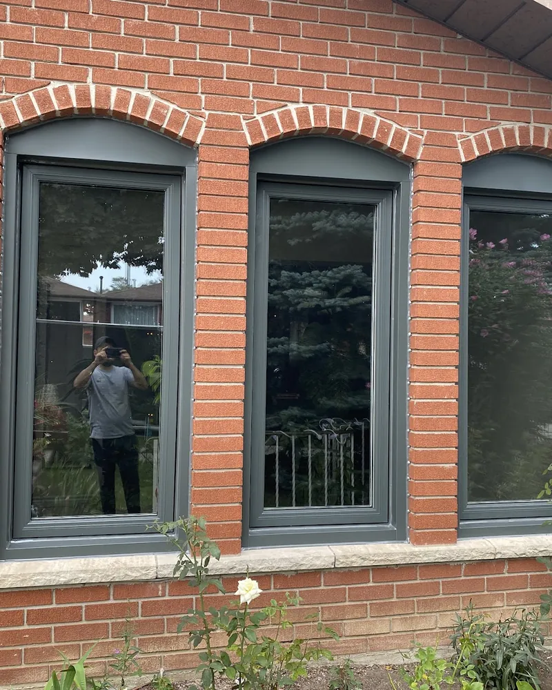 Three Arched Windows Replaced: after Three windows under brick arches after replacement