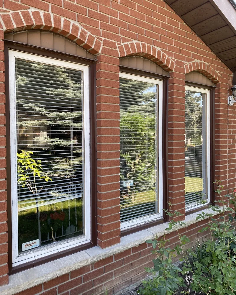 Three Arched Windows Replaced: before Three windows under brick arches before replacement