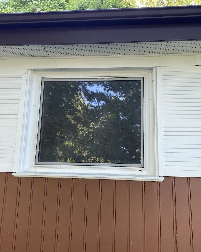 Window between white shutters before replacement